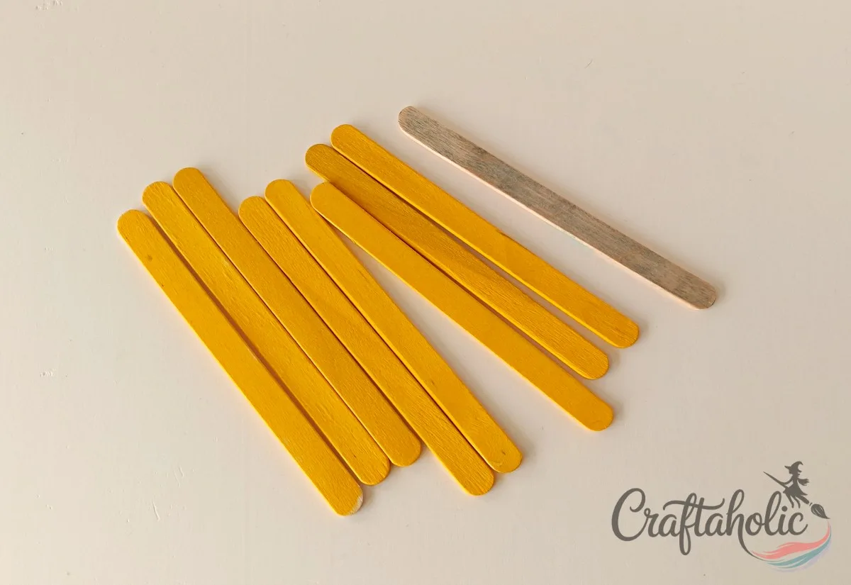Painting popsicle sticks yellow and grey Painting popsicle sticks yellow and grey with acrylic markers