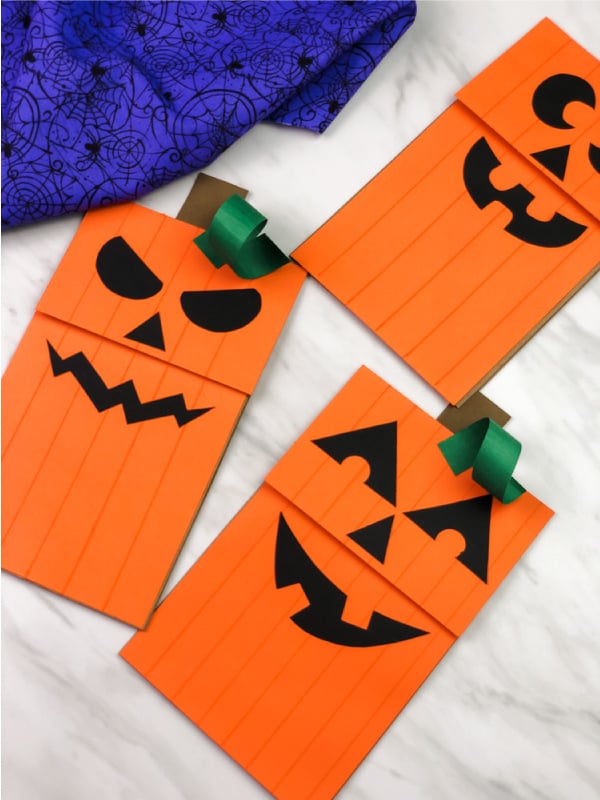 20 Easy Halloween Paper Crafts for Kids to Make at Home 11 Pumpkin paper bag puppet: orange jack-o-lantern face craft made from a paper lunch bag