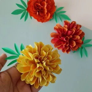 Close-up vertical shot of the realistic paper marigold flower craft
