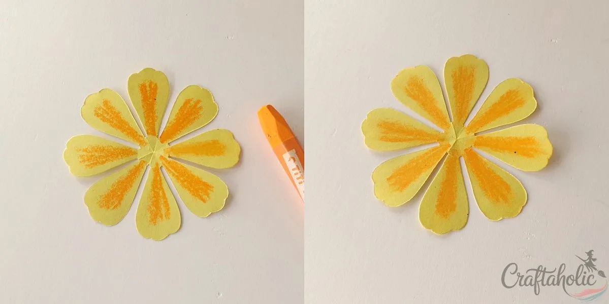 Shading the middle of a paper marigold petal with oil pastel crayon