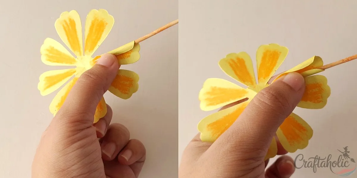 Curling paper marigold petal edges around a craft stick