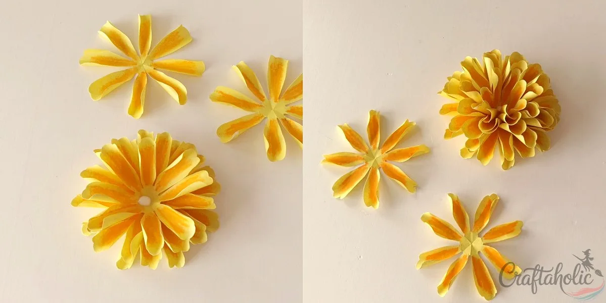 Gluing small petal layers on top to finish the paper marigold center