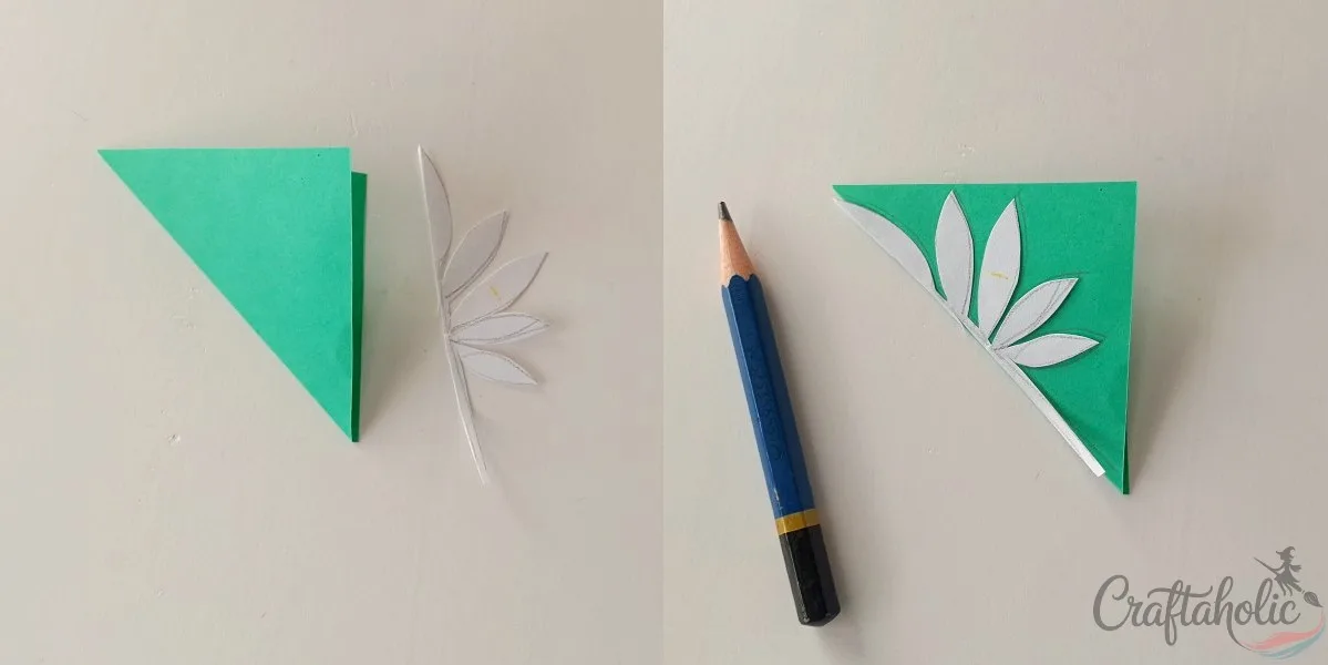 Tracing the leaf pattern onto folded green paper for the marigold