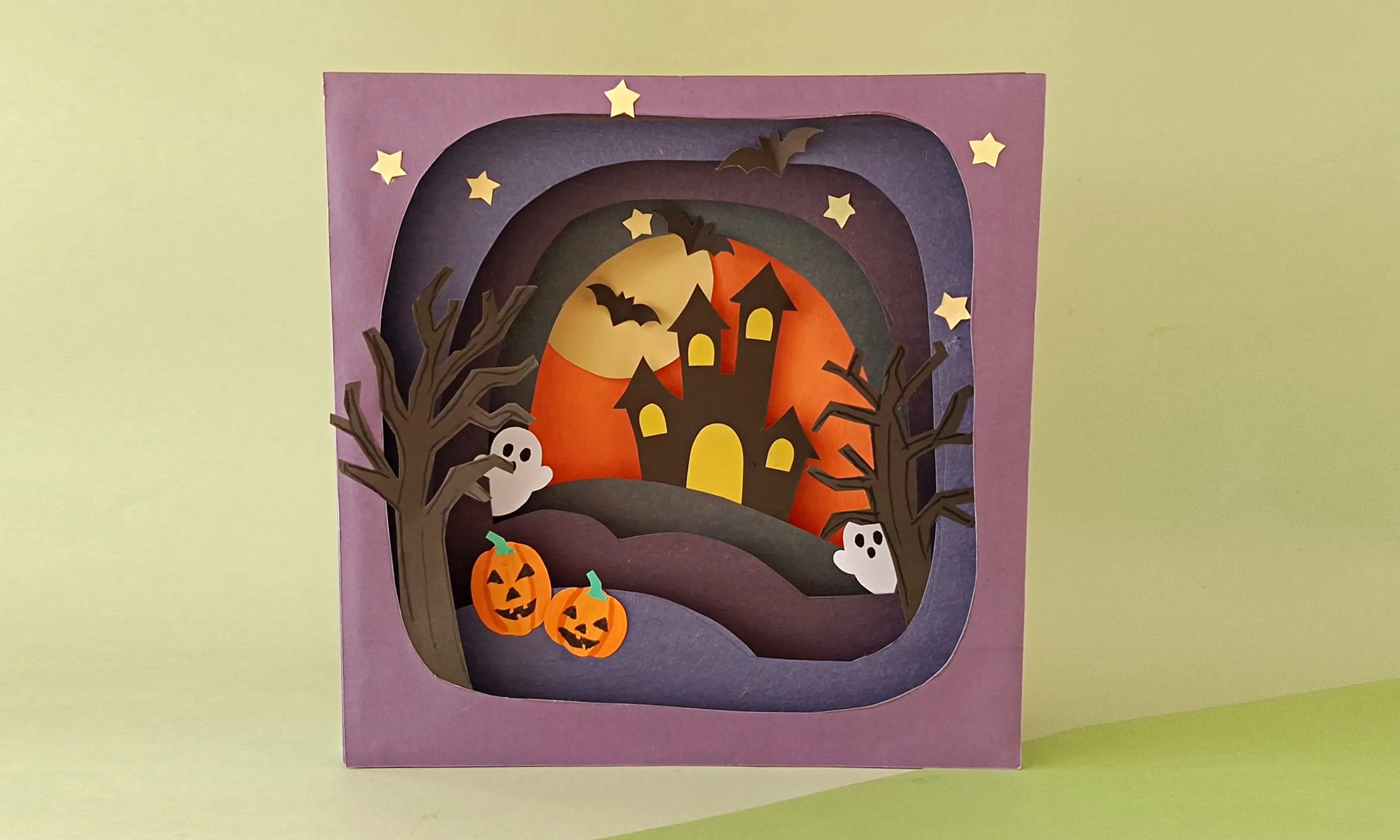 Finished 3D Halloween shadow box Finished 3D Halloween shadow box made from layered paper art, showing a haunted house under a full moon