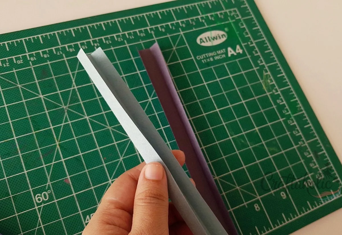 Folding a spacer strip into thirds Folding a paper strip along two crease lines to make a 3D spacer strip