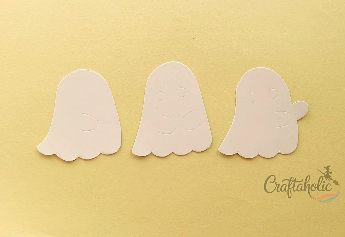 Tracing and cutting the ghost bodies Cardstock ghost shapes traced and cut out for a ghost lollipop holder