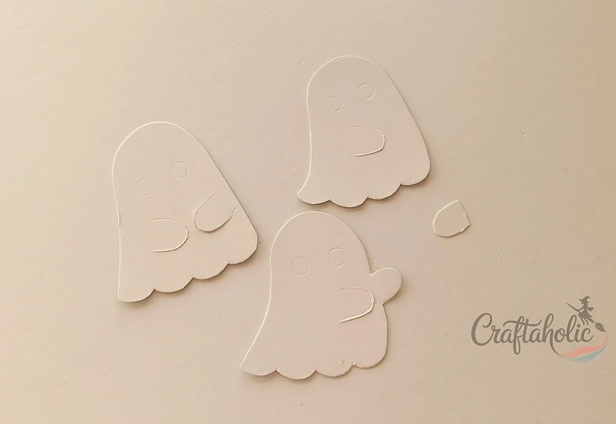 Cutting slits into the ghost arms Slits cut into the ghost's arms to hold the lollipop stick