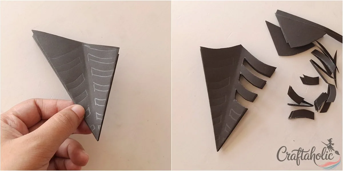 Tracing the spider web pattern on the folded paper with a pencil