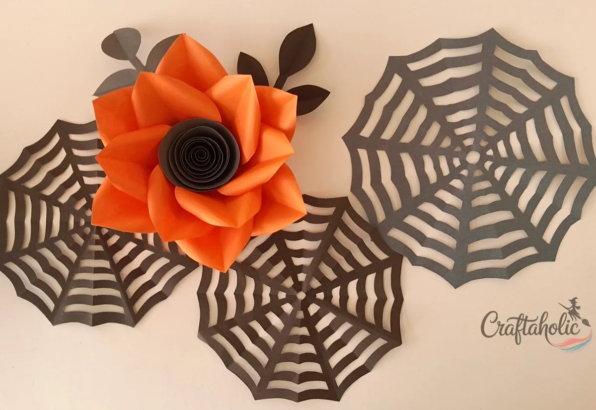 Attaching the spider webs, big flower and leaf branches to the wall
