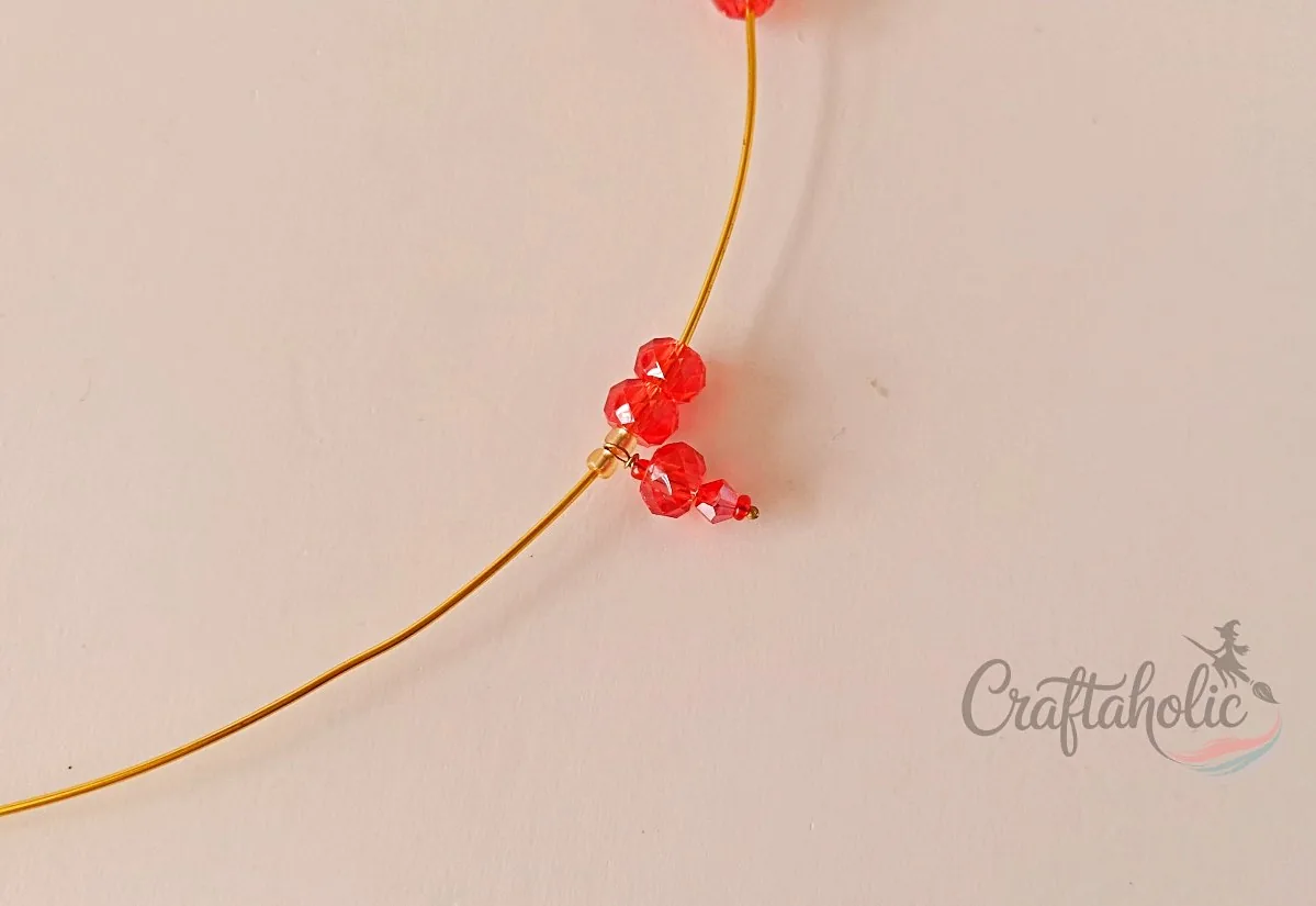 Beaded choker necklace, step 9 Inserting a bead charm onto the choker base wire