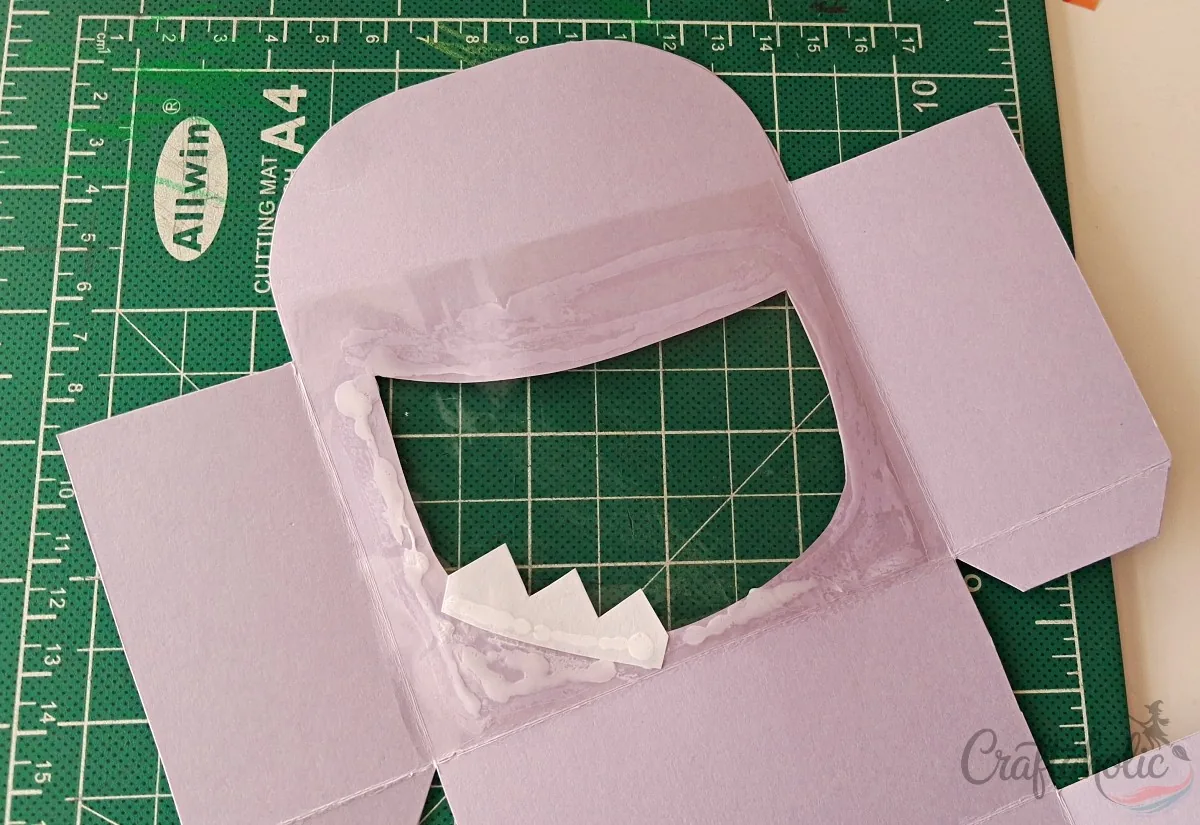 Attaching teeth and clear sheet to the monster snack box
