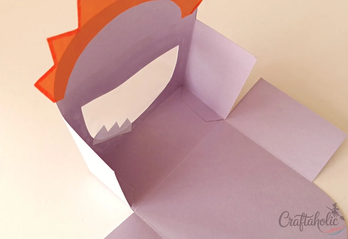 Folding and attaching the thin flaps of the monster snack box