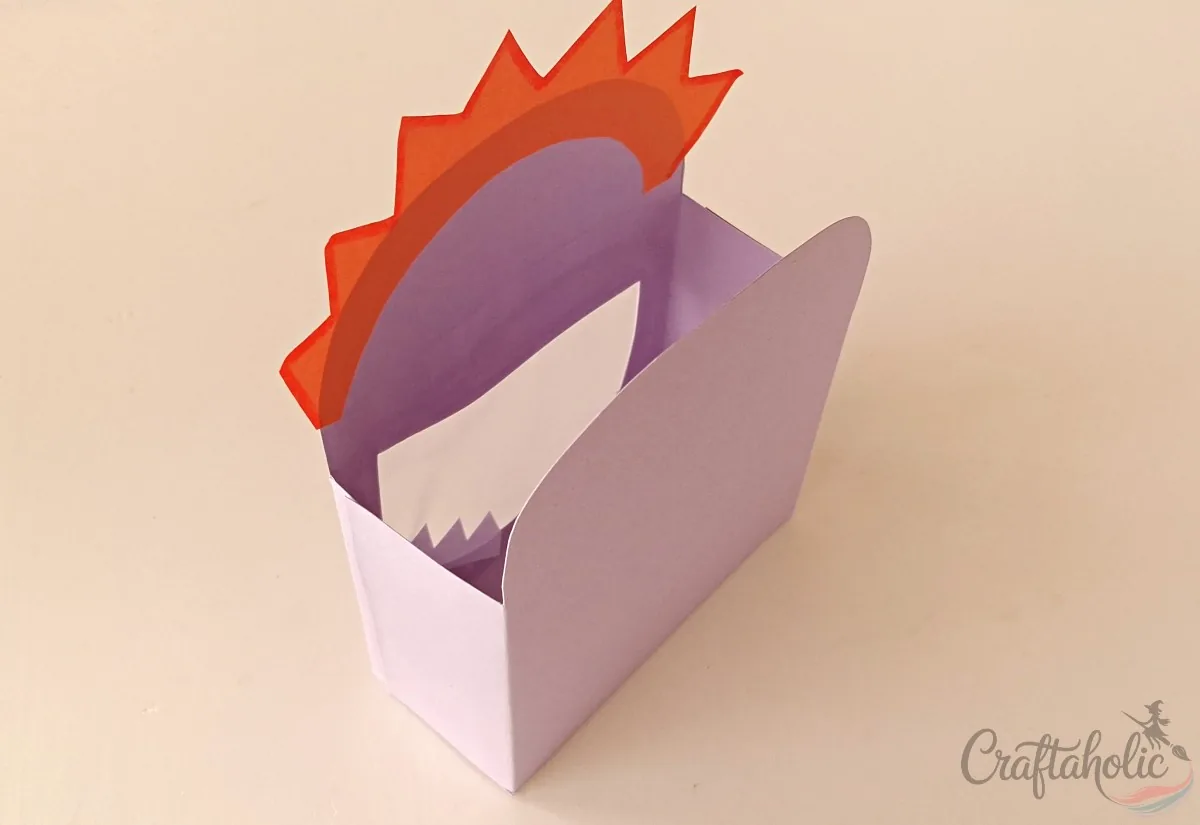 Folding and joining the side flaps to complete the monster snack box