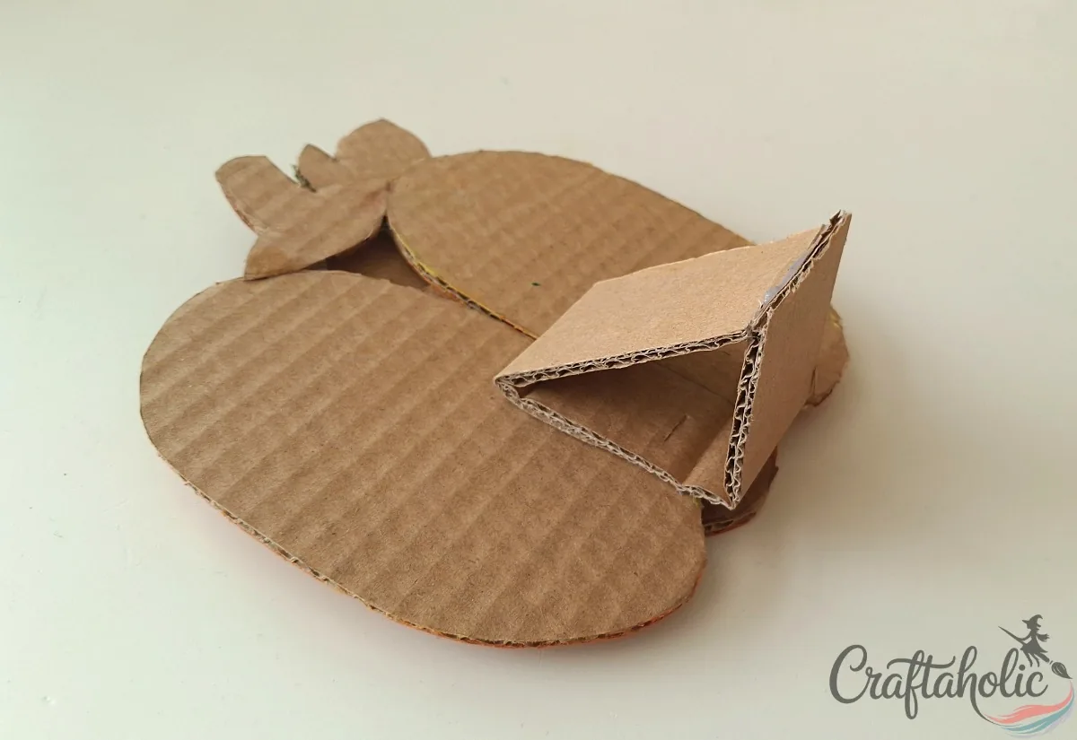 Folded cardboard triangle stand glued to the back of the cardboard pumpkin