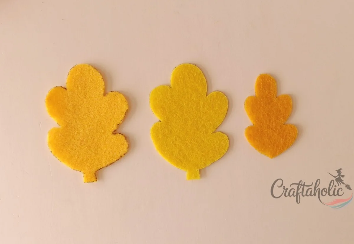 Felt leaf ornament, step 1 Yellow felt leaf base and inner leaf cutouts for the fall leaf ornament