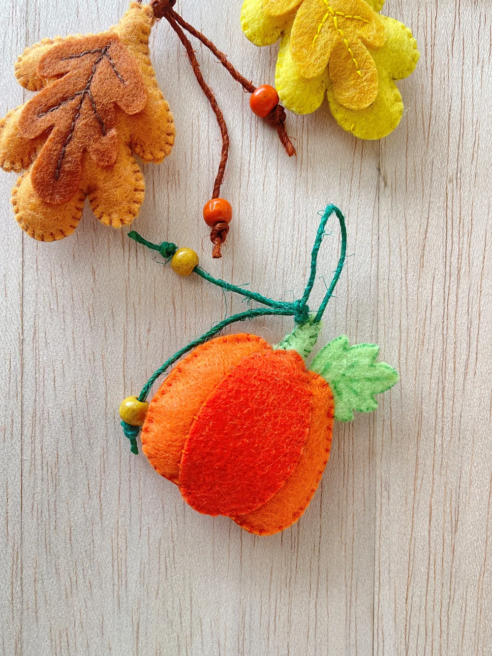 Finished felt pumpkin ornament Finished orange felt pumpkin ornament with a green leaf and a hanging loop