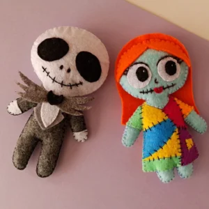 Finished Jack and Sally felt dolls from The Nightmare Before Christmas laid side by side