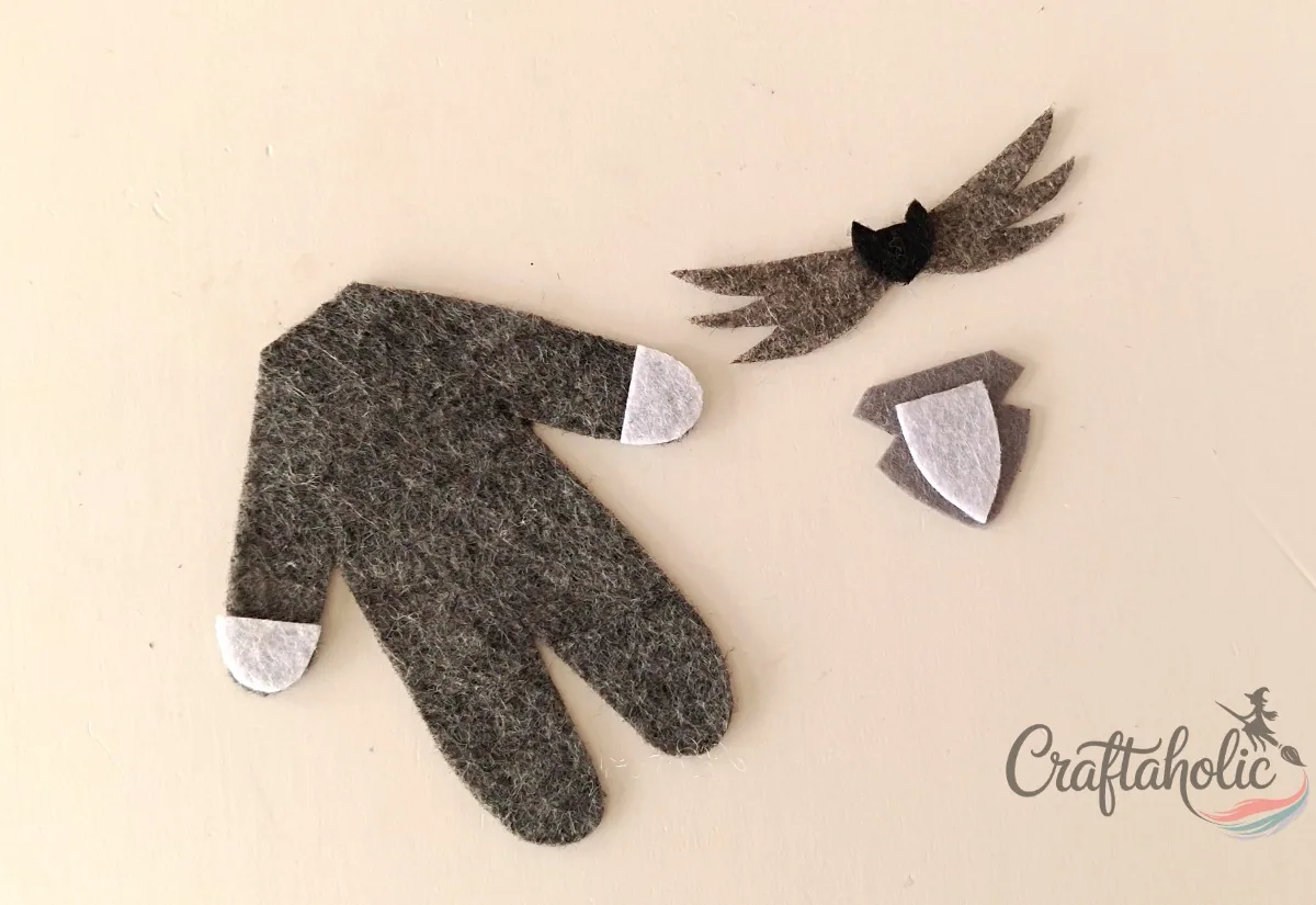 Jack's front pieces Hand cutouts, bat tie and shirt pieces arranged on the felt Jack doll body base