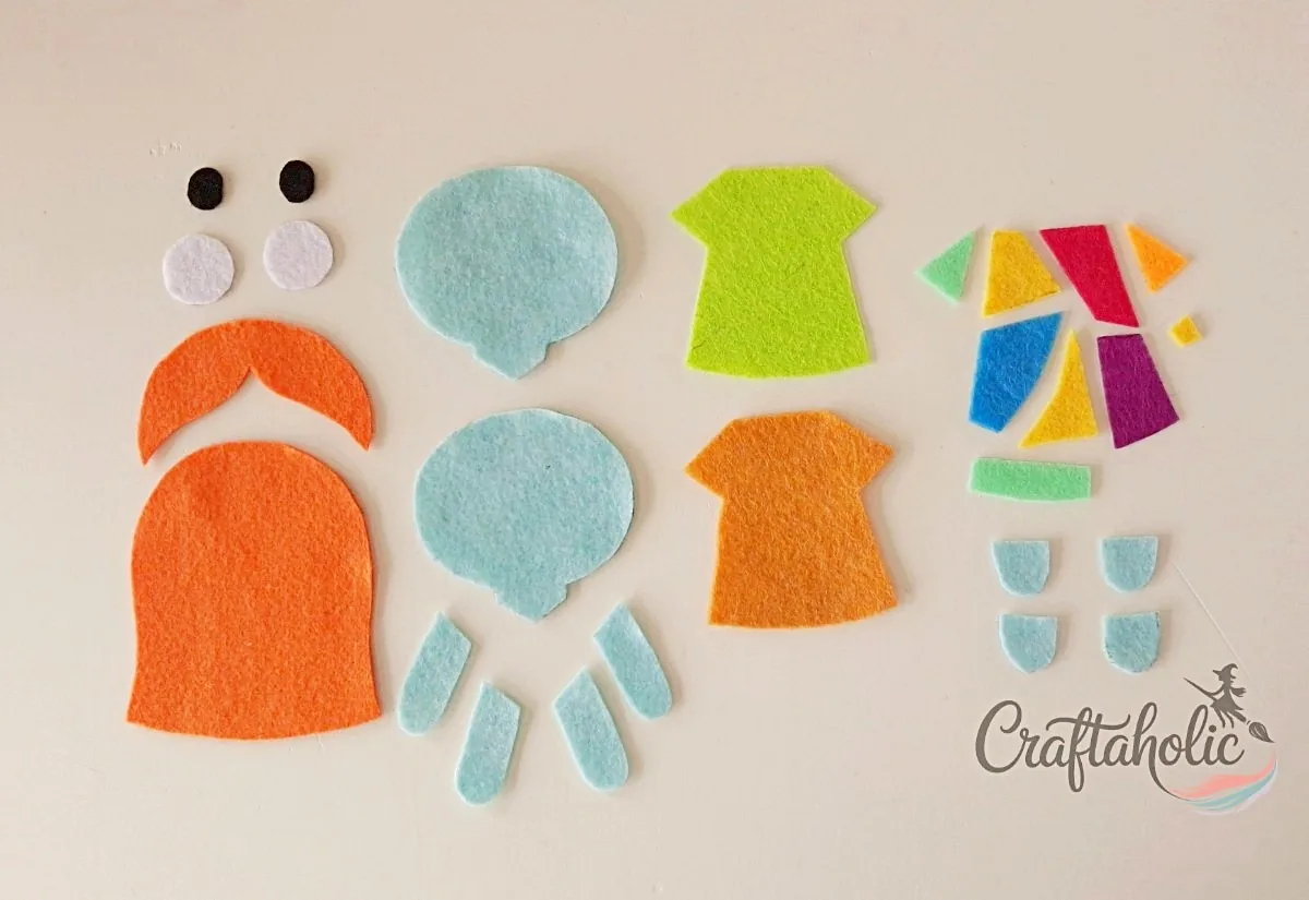 Sally's cut felt pieces Sally felt doll pattern pieces cut out from colored felt on a flat surface