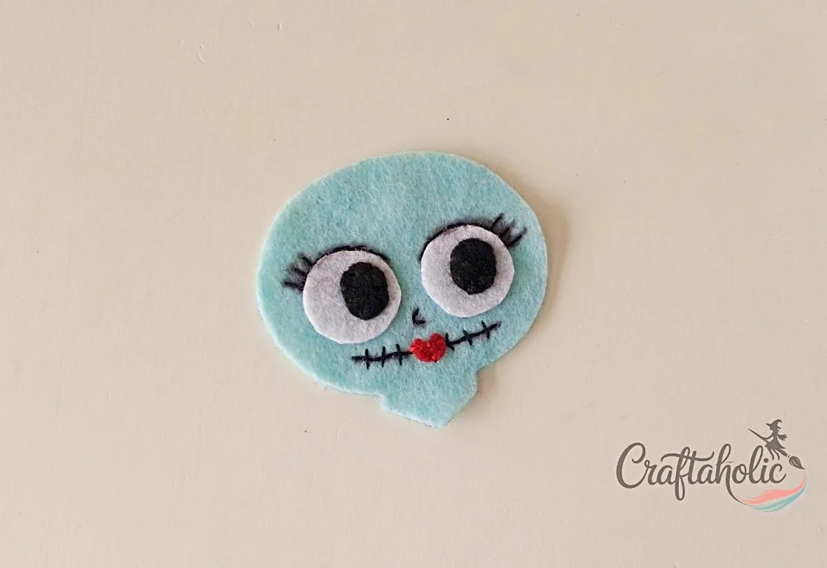 Sally's stitched face Stitched eyes, lips and mouth stitches on the felt Sally doll head