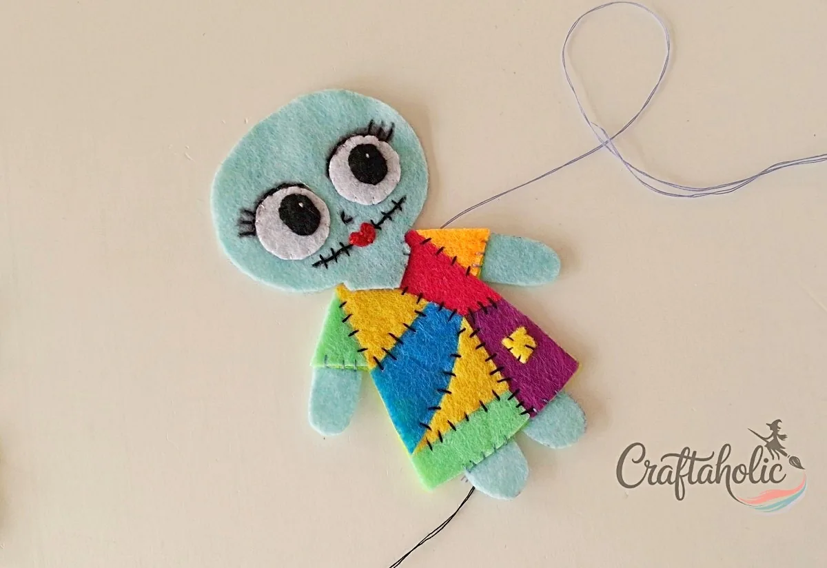 Face joined to the dress Felt Sally doll front part with the head stitched to the patchwork dress