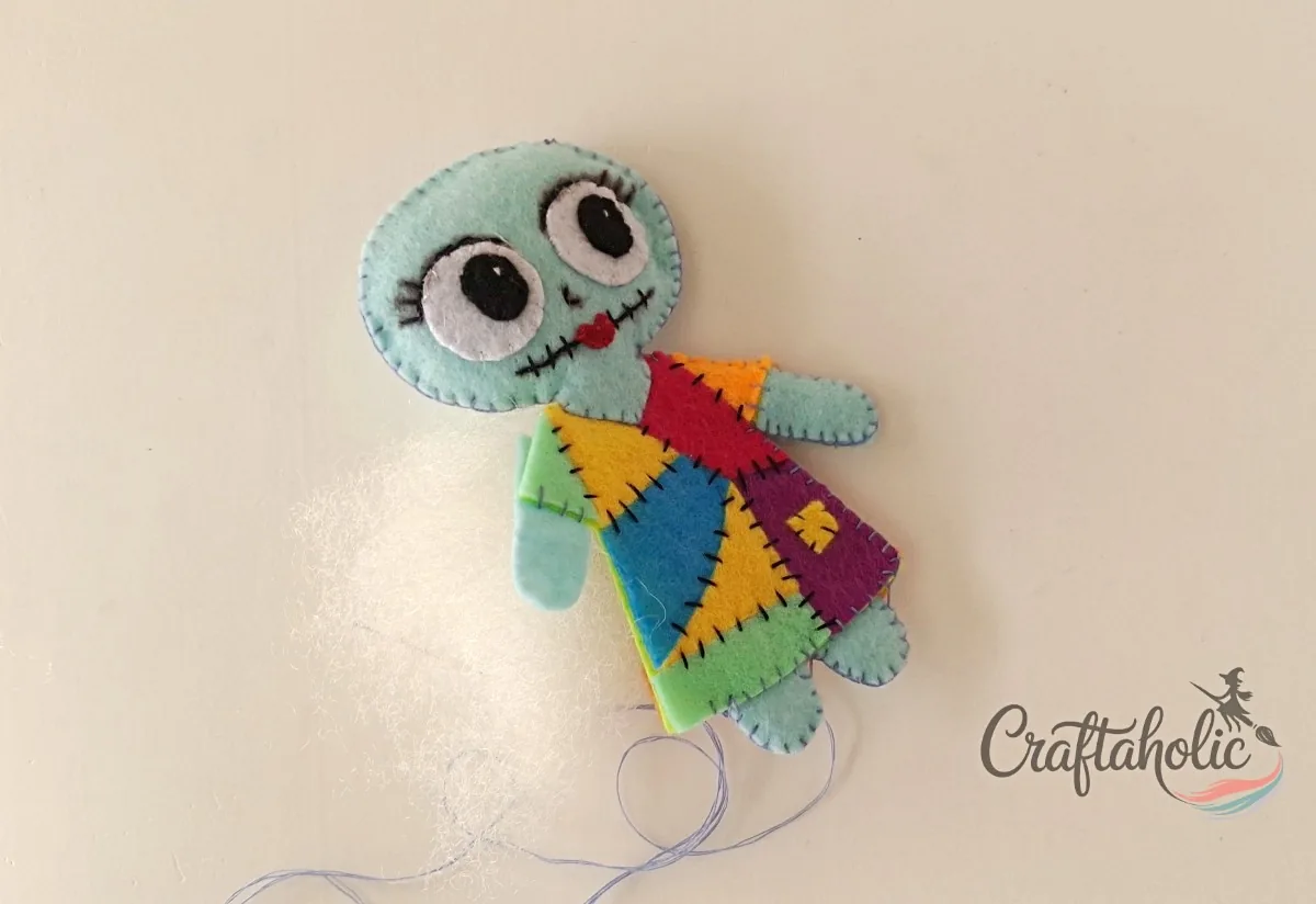 Stitching and stuffing Sally Blanket stitching around the sides of the felt Sally doll while stuffing the body