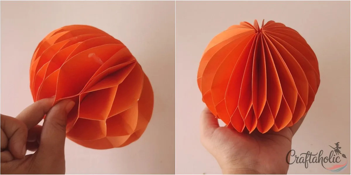 Closing the pumpkin Pulling the open sides of the paper stack together to form a round honeycomb pumpkin